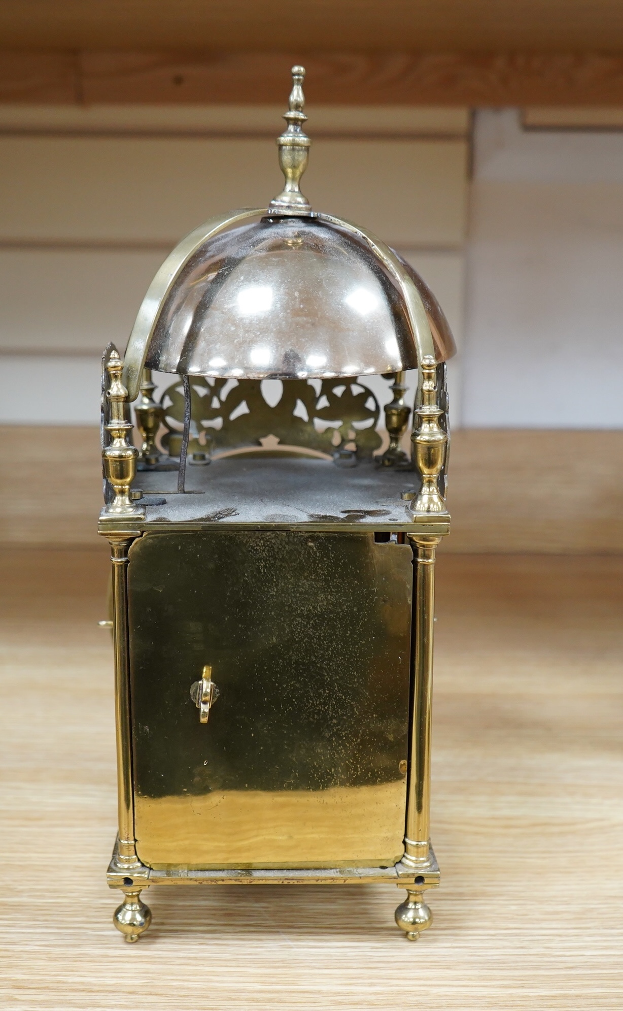 Manner of Richard Rayment of Bury. A Victorian 17th century style lantern clock, in traditional brass case with silvered Roman dial and eight day single fusee movement striking on a bell, 17cm wide, 14.5cm deep, 38cm hig